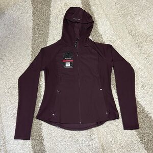 Spyder quick dry, full zip light coat. Zippered pockets. Thumb holes.